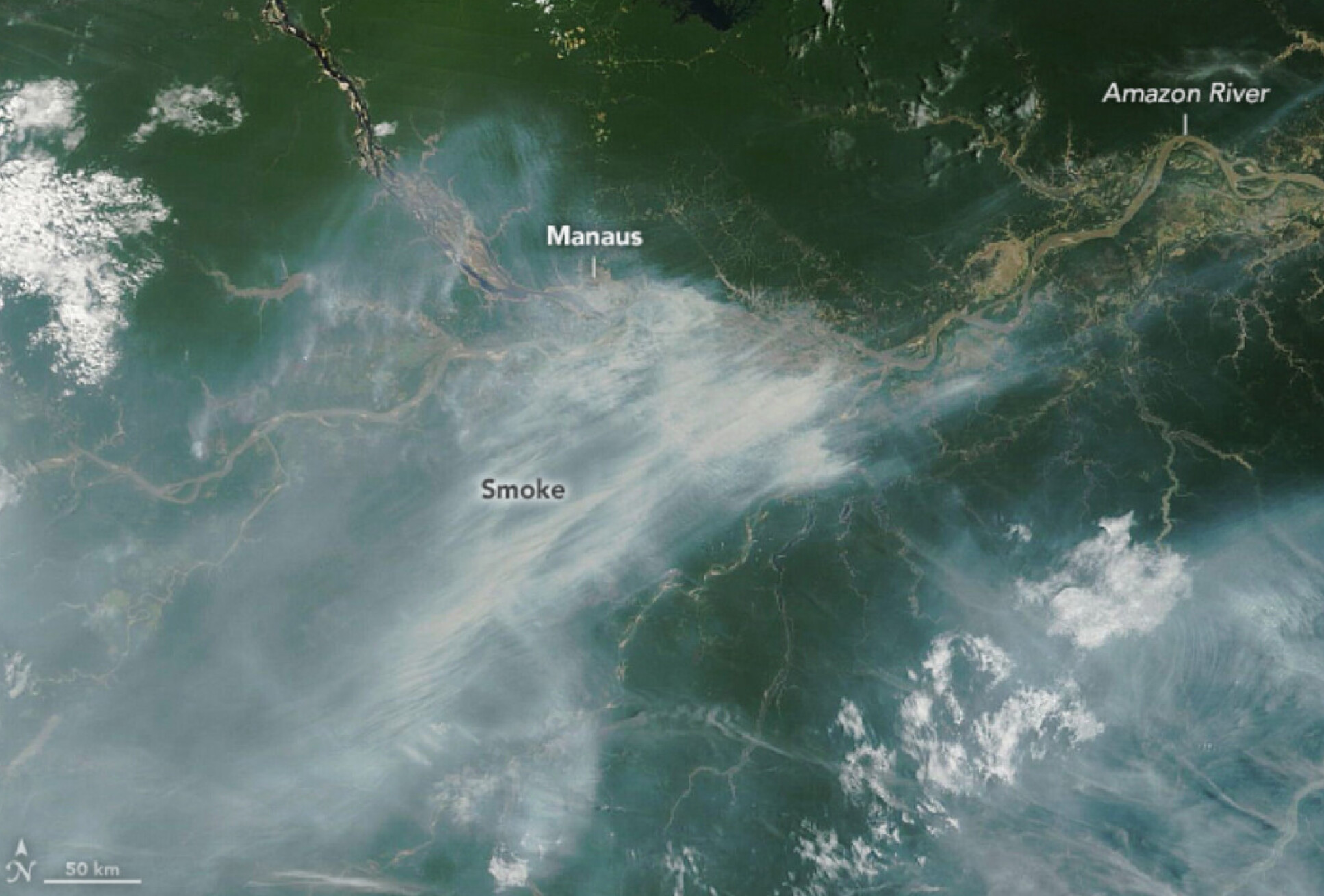 A satellite image showing smoke from wildfires over the Amazon rainforest