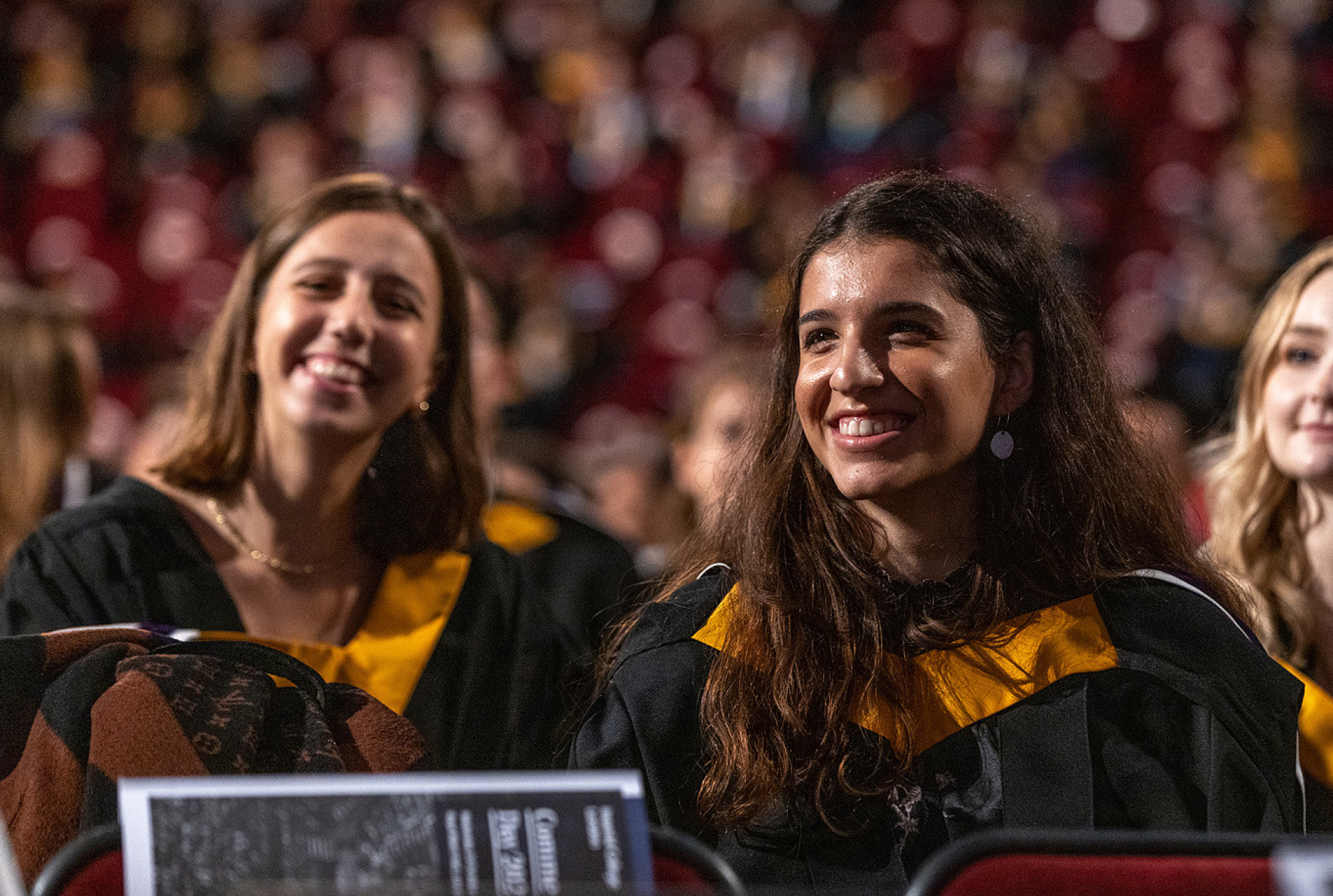 three young women in gowns in the Royal Albert Hall