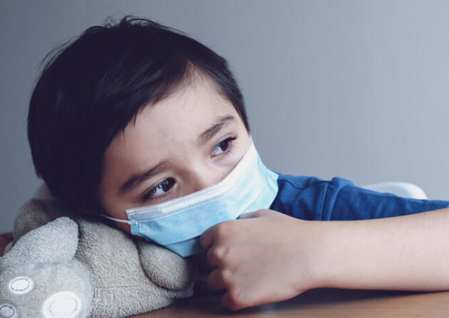 A child during the pandemic wearing a face mask