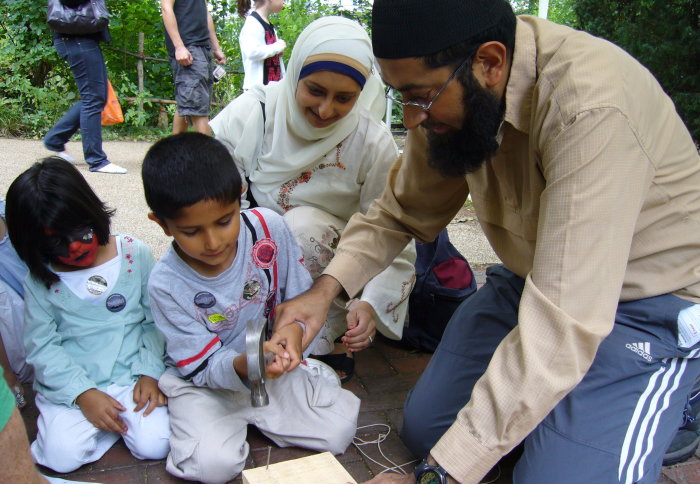 A family constructing a bat box