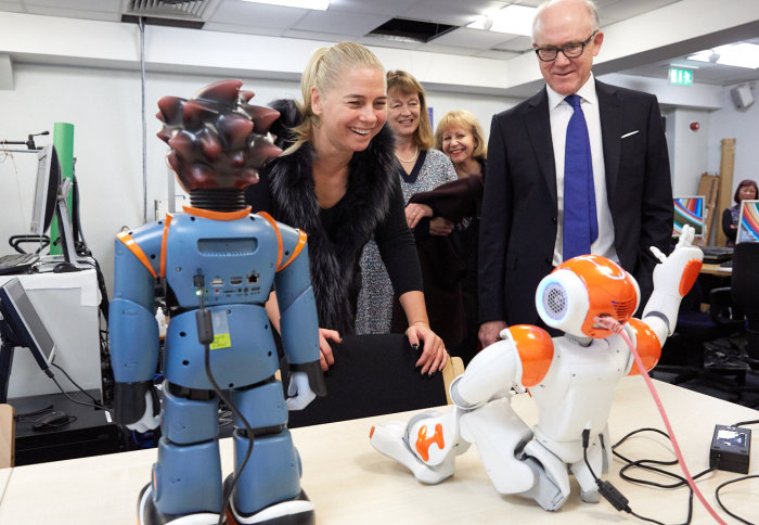 Maja Pantic shows Ambassador Johnson her group's emotive robots