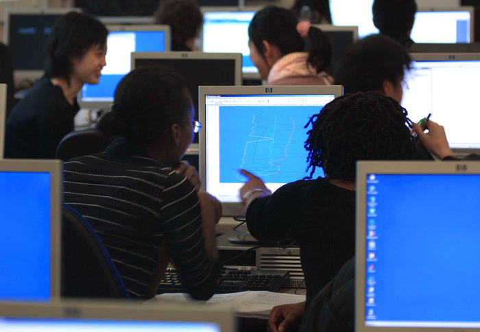Students looking at computer screen
