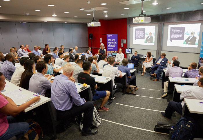 Alumni listen to the presentation in a lecture theatre