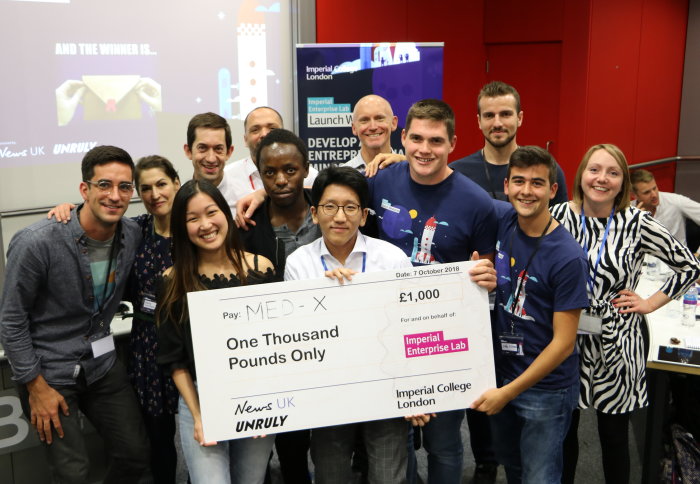 Students holding a giant cheque