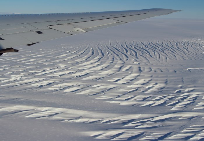 An aerial view of large crevasses in a glacier
