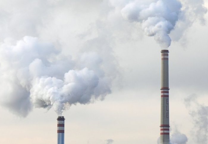 carbon dioxide being released from industrial funnels