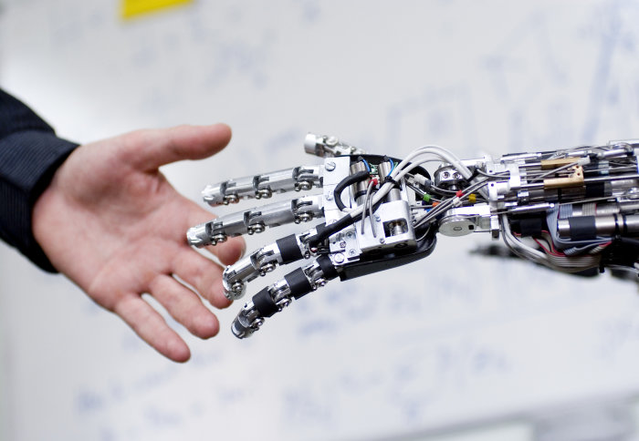 Robot and human hand connecting.