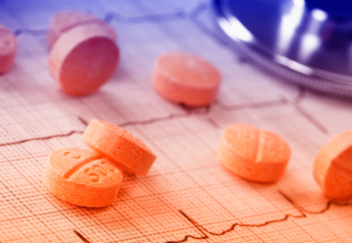Concept image of pills on an electrocardiogram read out