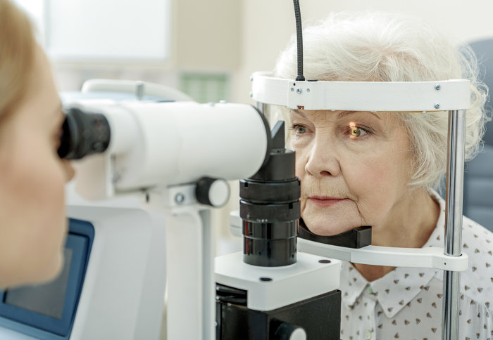 An elderly woman getting an eye test