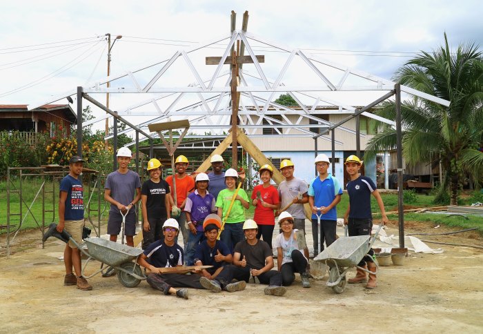 Group of students standing in front of construction of building
