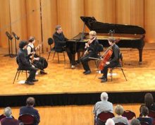 A pianist and string quartet perform