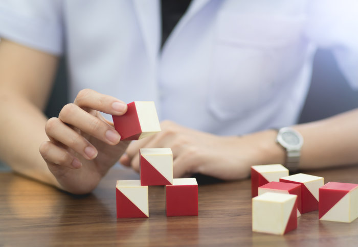 A woman plays with a block puzzle