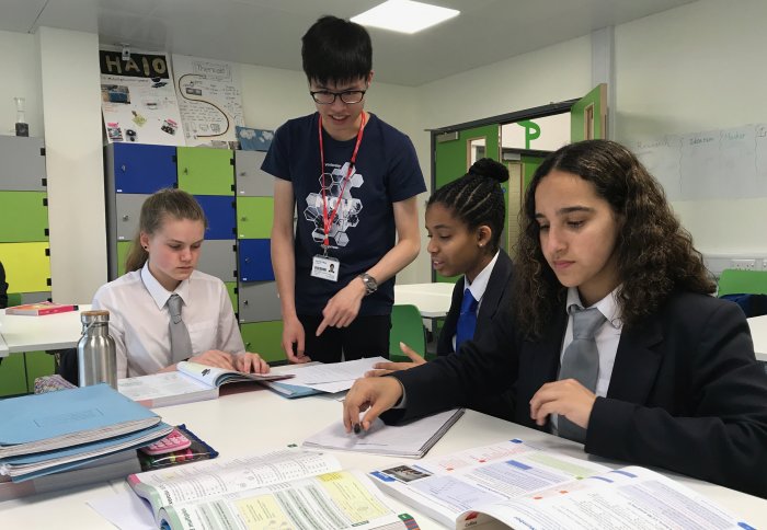 Imperial student with school children at the homework club