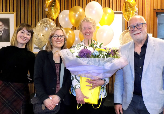 Professor Jo Haigh holding a bunch of flowers at her retirement celebration in the Department of Physics in 2019.