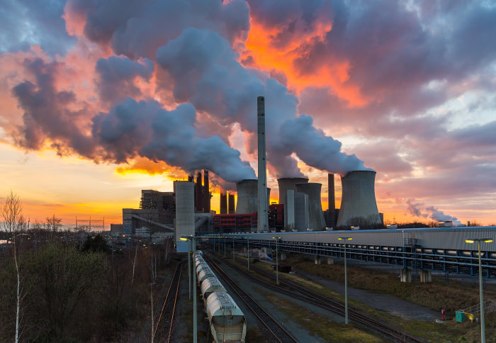 A power plant with steam coming out of vents