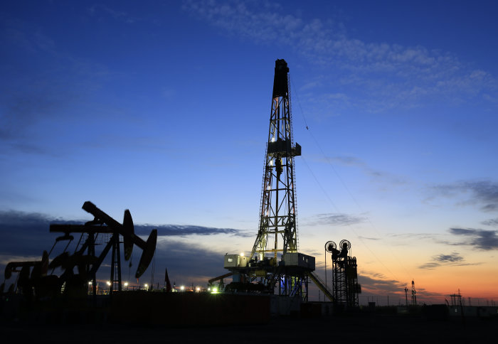 Oil rig against sunset