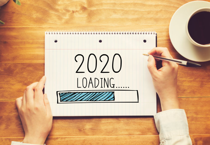 The words '2020 loading' written on a pad of paper
