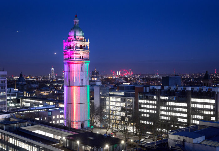 Queen's Tower lit up in rainbow colours during the evening