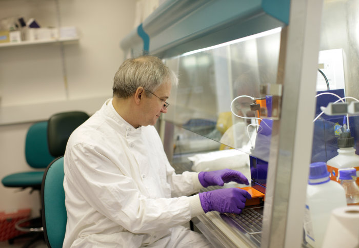 Peter Openshaw working with chemicals in a fume hood