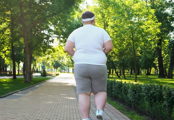 Overweight man running in a park