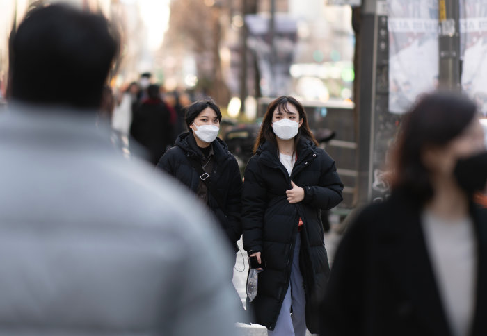 People wearing masks near the Hongik University Station in Seoul, South Korea