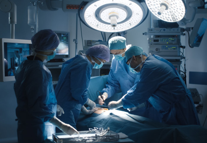 People conducting surgery