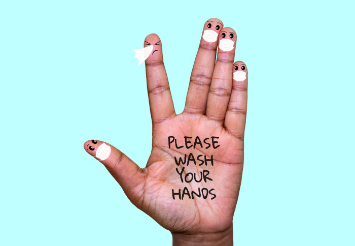 A hand with finger faces wearing face masks with one finger sneezing. The hand has 'please wash your hands' written onto the palm.
