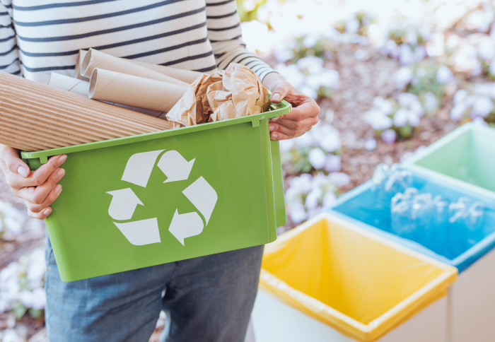 Person recycling card and paper