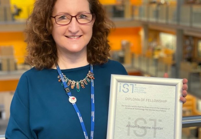 Allison holds her IST Fellowship award certificate