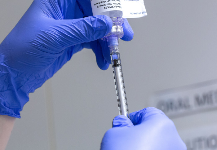 A vaccine being drawn from a vial