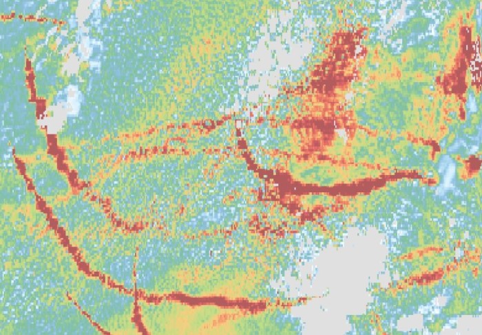 False-colour satellite image showing lines of red that corresponds to ship tracks