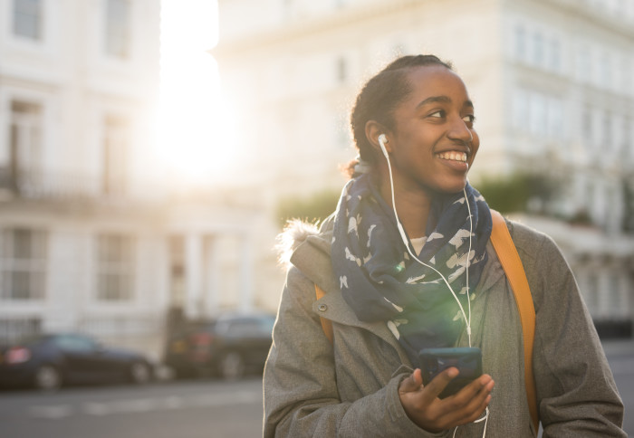 Woman with headphones on Exhibition Road