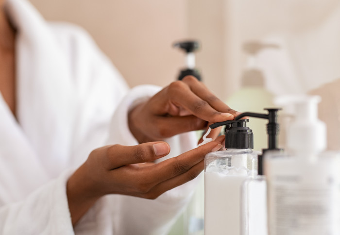 A woman using a soap dispenser