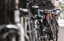 Bikes leaning on railings on street