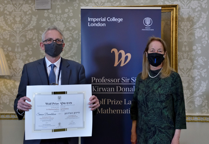 Professor Donaldson holding his certificate and President Professor Gast