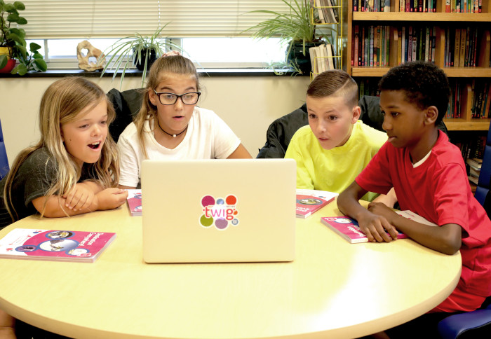 Four children watching an educational video on a laptop