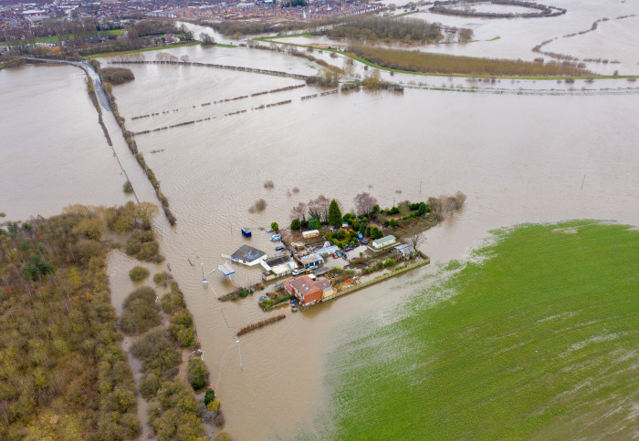 Aerial drone photo of the town of Allerton Bywater near Castleford in Leeds West Yorkshire showing the flooded fields and farm house from the River Aire during a large flood after a storm