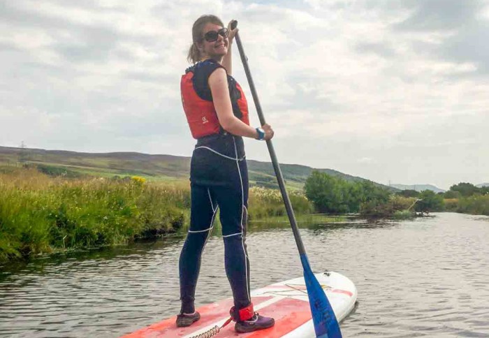 Dr Caroline Wainwright paddleboarding on a river