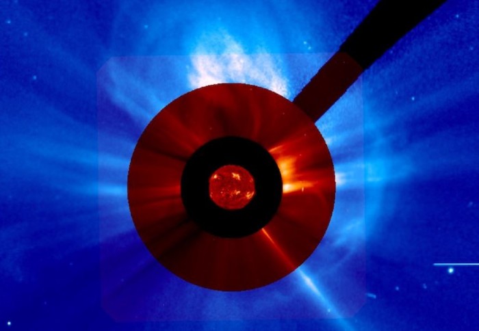 Picture of the Sun with the main disk obscured by dark red filters, and an explosion of matter seen around the edge, highlighted in blue