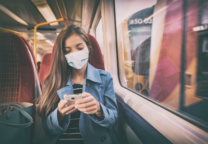 Woman on a train wearing a mask
