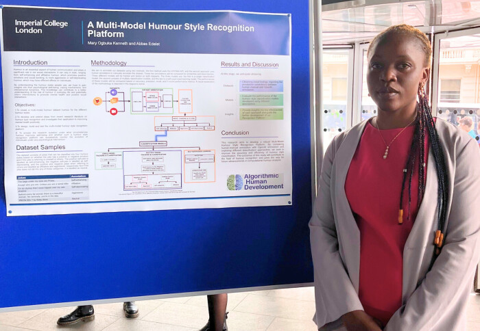 Photo of Mary in front of her research poster