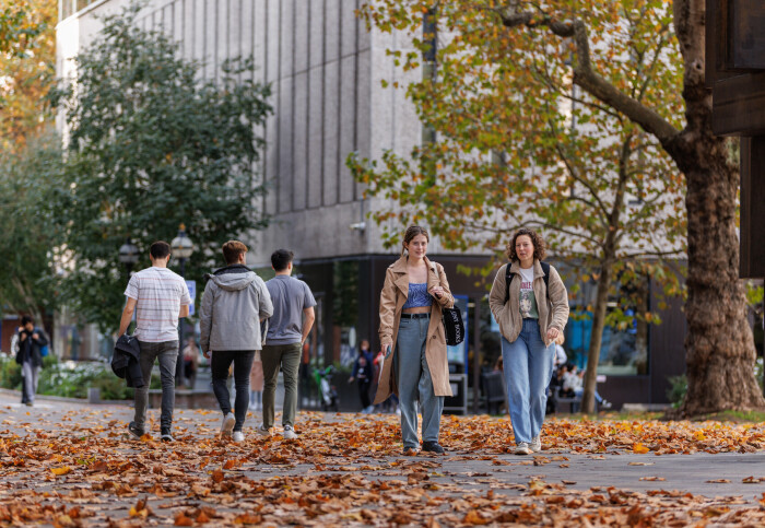 Students walking across the South Kensington campus in the autumn
