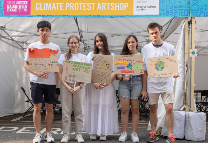 Young people holding placards they designed to protest the climate emergency