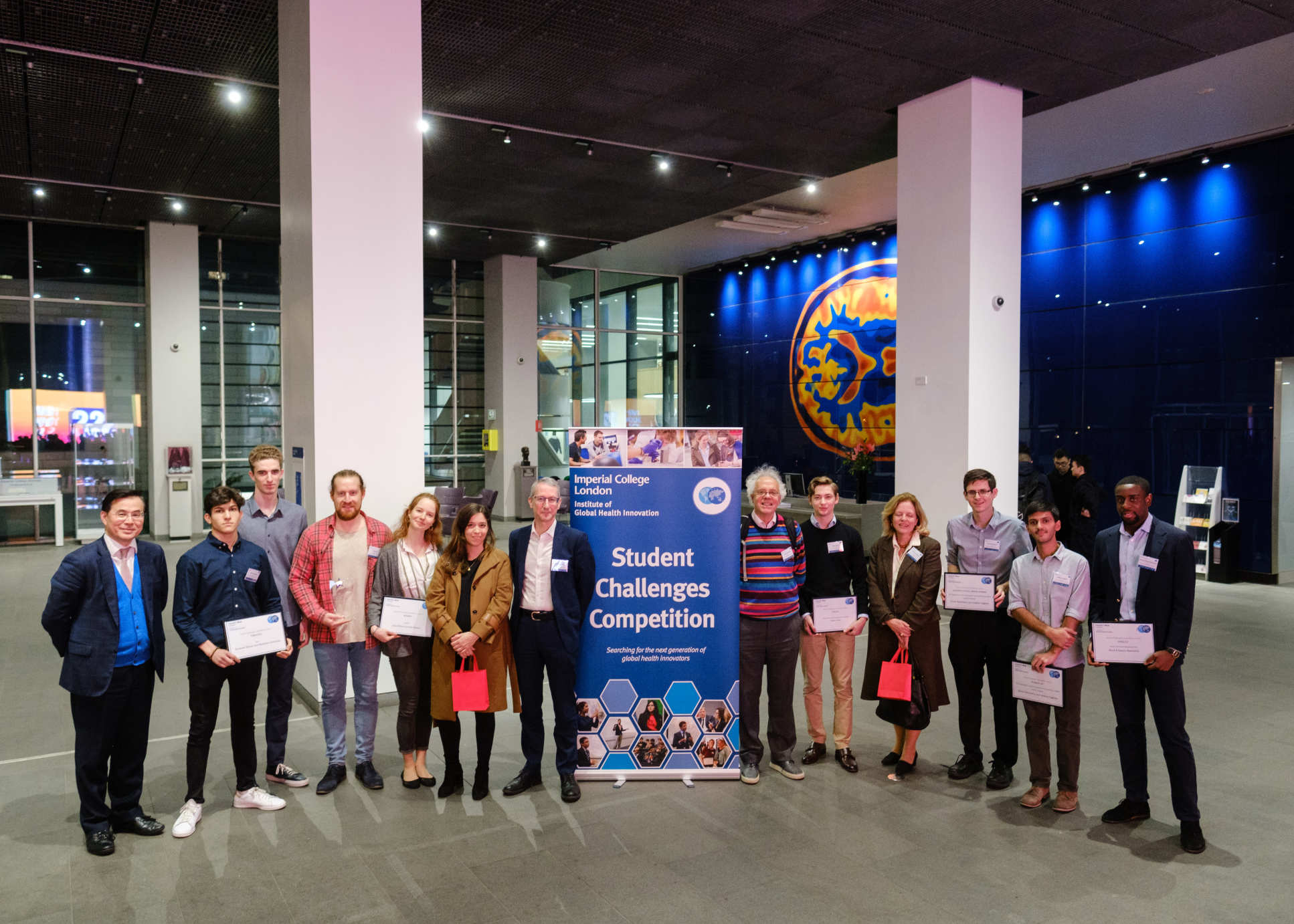 A photograph of all the finalists and judges with their certificates. 