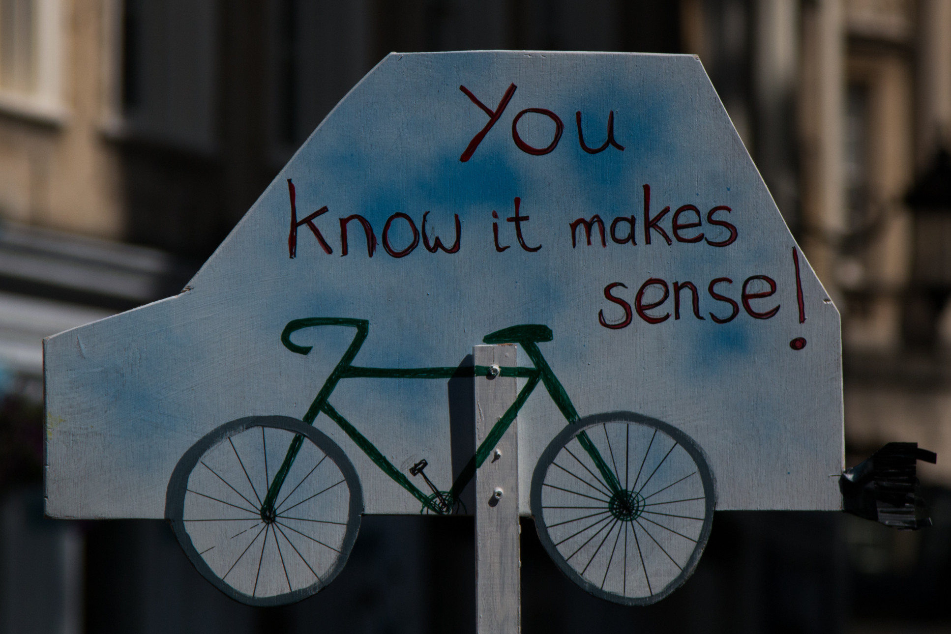 Cut-out of a car with a bike drawn on it, that read 'you know it makes sense'