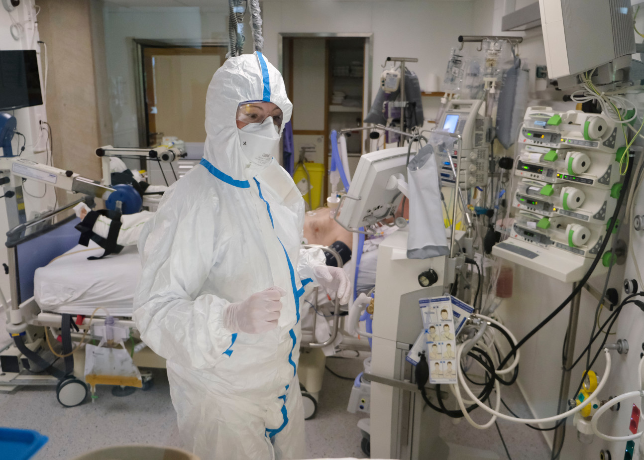 A patient and a doctor in an intensive care unit