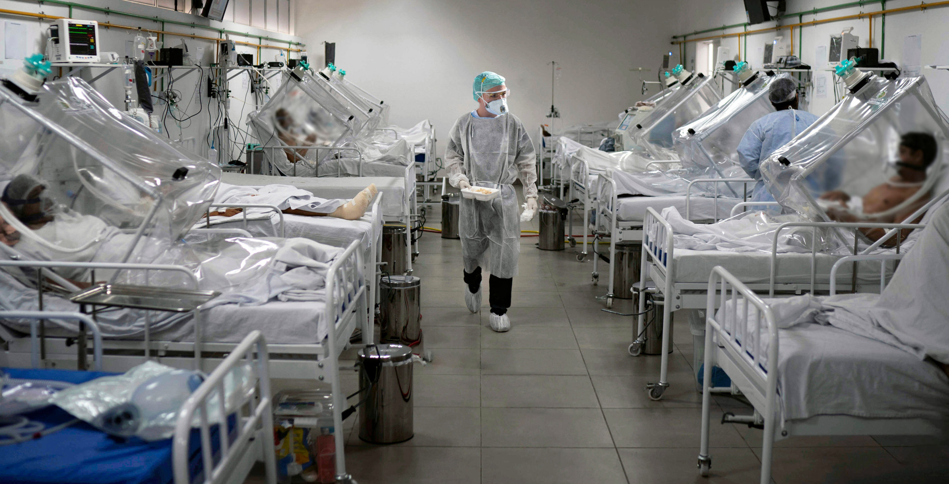 Photo: medical staff work in the Intensive Care Unit (ICU) for COVID-19 with multiple patients on ventilators.