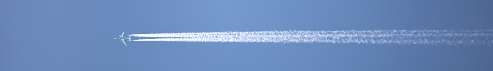 A plane with contrails behind it