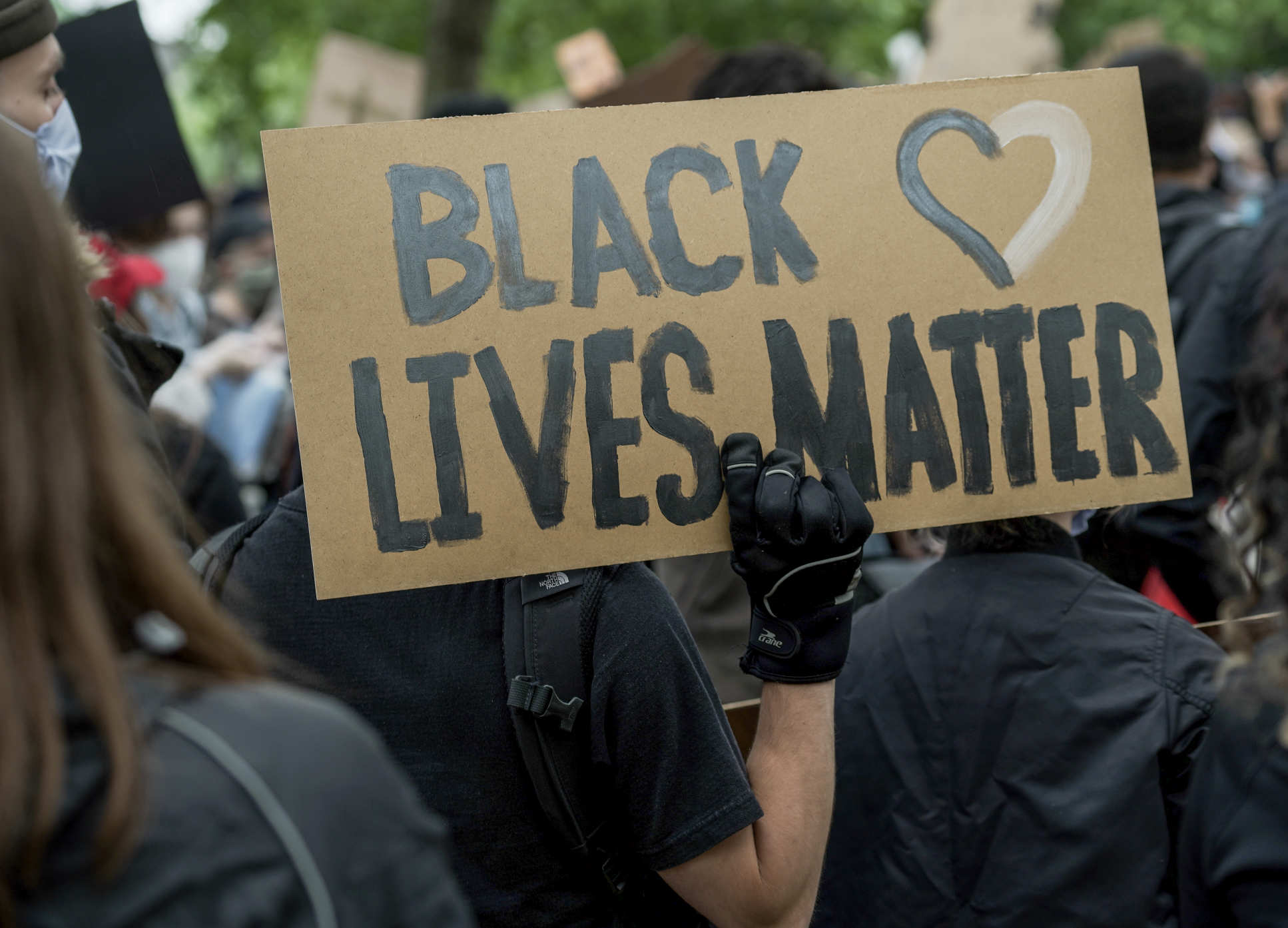 A close up shot of a protester carrying a Black Lives Matter Placard in Hyde Park, London on the 3/6/2020