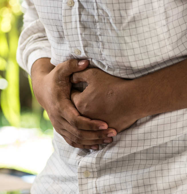 Photo of man clutching tummy in pain